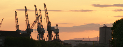 The shipyard's cranes at dusk